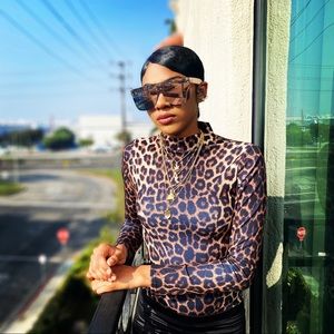 Medium full coverage bottom animal print black and brown bodysuit.